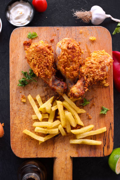 istock Delicious homemade crispy fried chicken with sauces on black marble background 1280136589