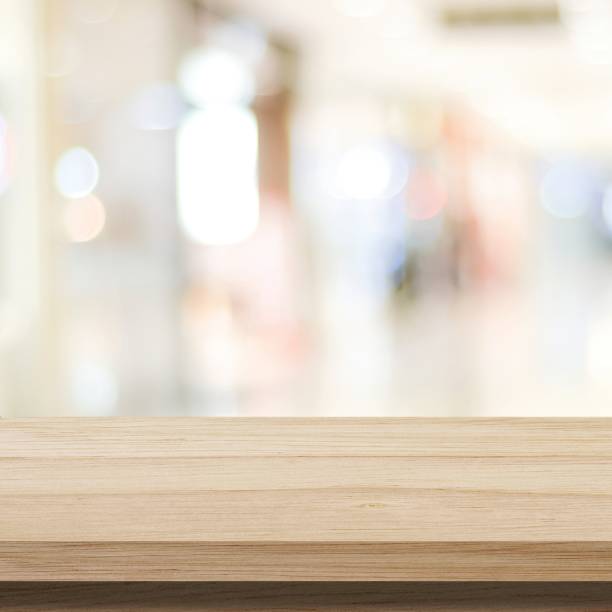 istock Table and blur background, Wooden counter over blur bokeh light background, Brown wood table top, shelf for food and retail shop, store product display backdrop, banner, mockup, template 1280136721