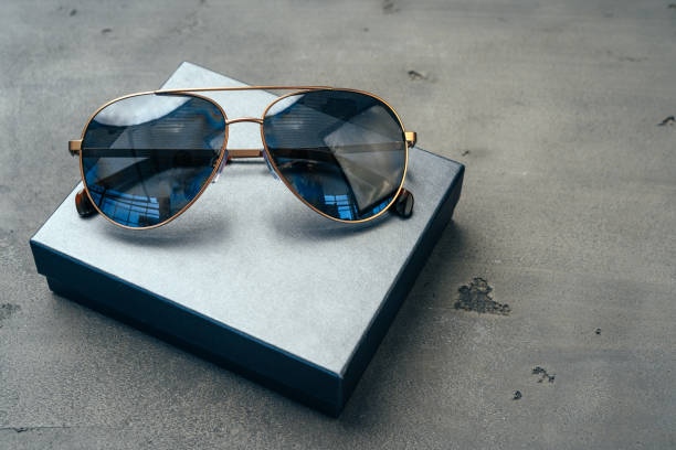 istock New dark aviator glasses on grey concrete background 1280137999