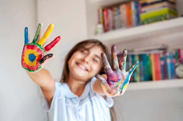 istock Cute girl playing with paints 1280138684