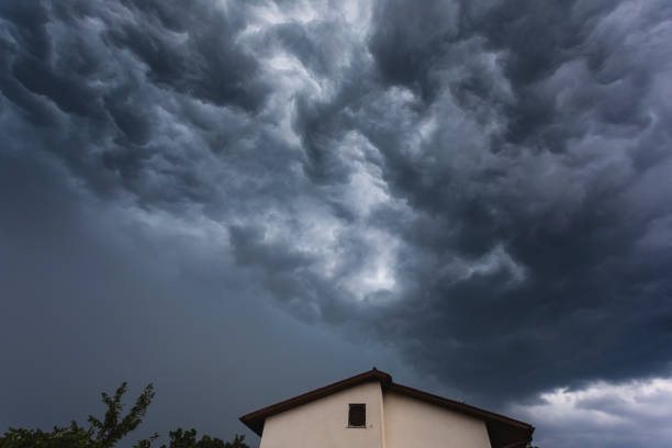 Roof Of House with Dramatic Storm Clouds Above stock photo