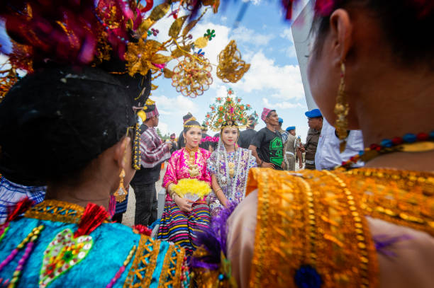 Unidentified Buton teenagers parading using special traditional carrier called Kansodaan during Wakatobi Wave Festival. This is an annual event in Southeast Sulawesi. stock photo