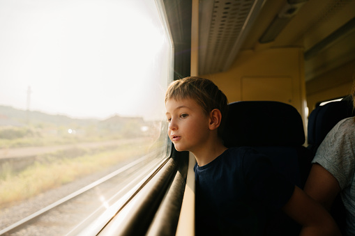 Photo of a young boy traveling by train
