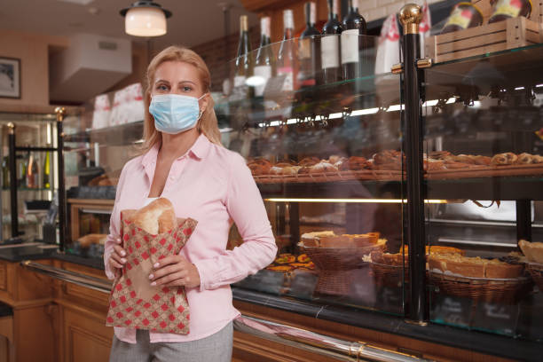 istock Woman shopping at bakery store 1280143628