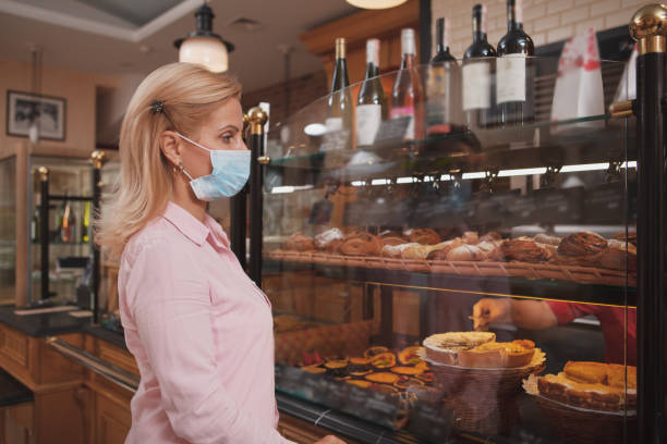 istock Woman shopping at bakery store 1280143671