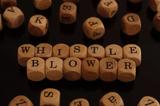 Wooden blocks with the word Whistleblower