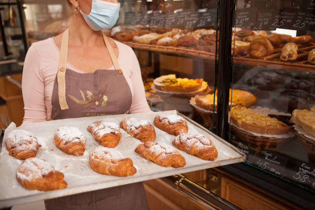 istock Mature female baker working at her shop 1280143834