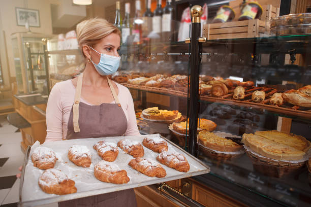 istock Mature female baker working at her shop 1280143919