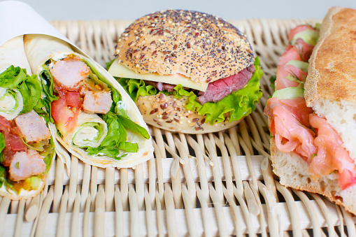 Studio photo of an appetizing sandwih, wrap and burger set