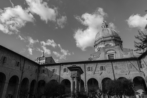 The basilica of Santa Maria degli Angeli is a Roman Catholic rite church located in Assisi, in the hamlet of the same name, built to a project by Galeazzo Alessi with interventions by Jacopo Barozzi da Vignola starting from the second half of the sixteenth century. It has the dignity of a papal basilica and inside there is the Porziuncola, the chapel where Francis of Assisi gathered in prayer, and for this reason the center of Franciscan spirituality. At the top of the facade of the temple stands the statue of the Madonna in gilded bronze modeled by Colasanti and cast by the Ferdinando Marinelli Artistic Foundry of Florence.