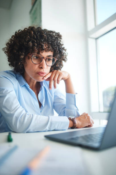 istock Business woman thinking about project working on laptop in office 1280146545