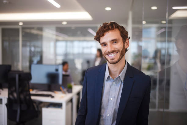 istock Young business man smiling in glass modern office 1280146674