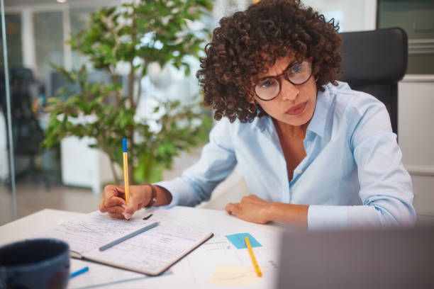 istock Business woman working on laptop and writing notes in desk 1280147363