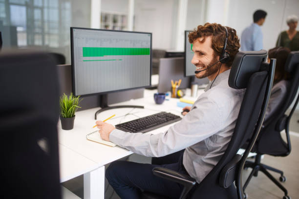 istock Happy man wearing headset working on call center 1280147669
