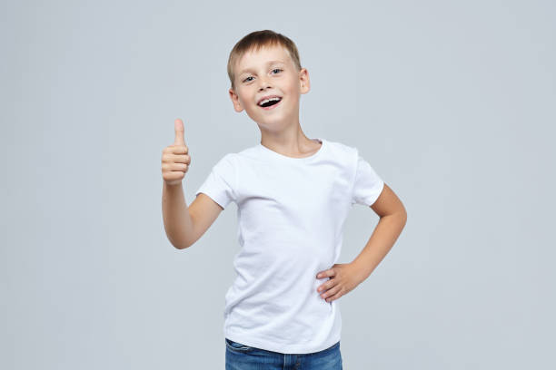 istock cute blond boy with a toothy smile. keeps thumbs up 1280149775