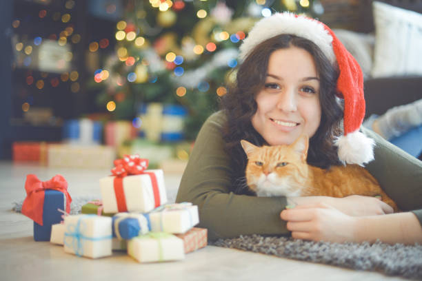 istock young woman in christmas interior with ginger cat 1280150843