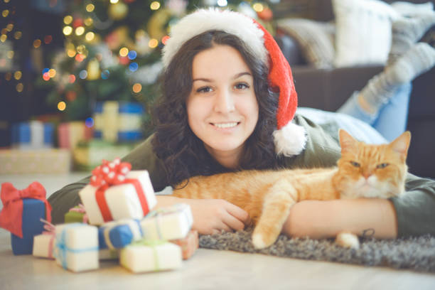 istock young woman in christmas interior with ginger cat 1280151266