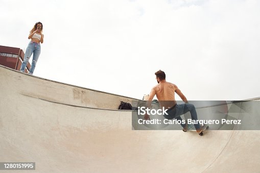 istock The man rides a skateboard in the bowl of a skatepark 1280151995