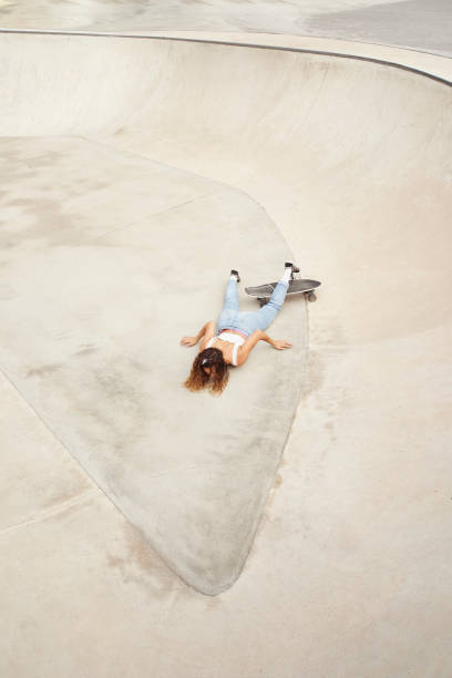 istock Young girl in skatepark fell while skating 1280152004