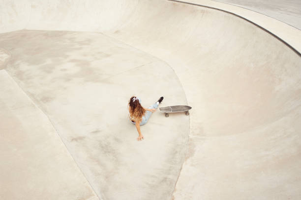 istock Young girl in skatepark fell while skating 1280152012