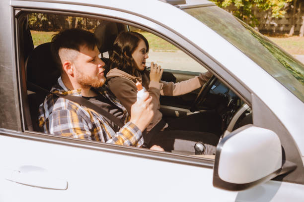 istock couple having chocolate snack while riding in car 1280152473