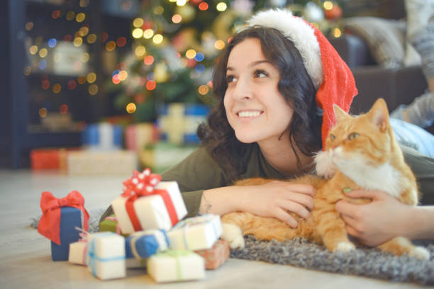 istock young woman in christmas interior with ginger cat 1280152677