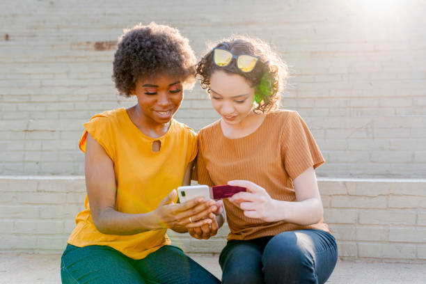 istock Friends making purchases via cell phone 1280155931
