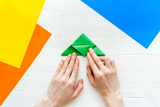 istock DIY concept. Doing origami paper bird, Top view 1280158510
