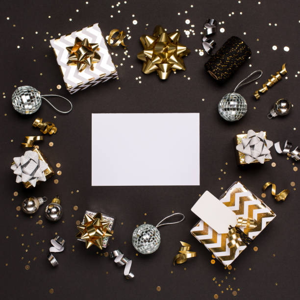 istock Christmas composition. Gold and silver decorations, mirror disco balls, gifts on  dark black background. 1280158955