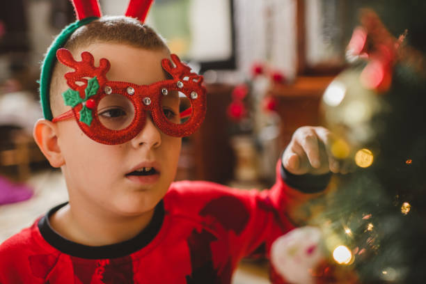 istock Caucasian boy decorating Christmas tree at home 1280159721