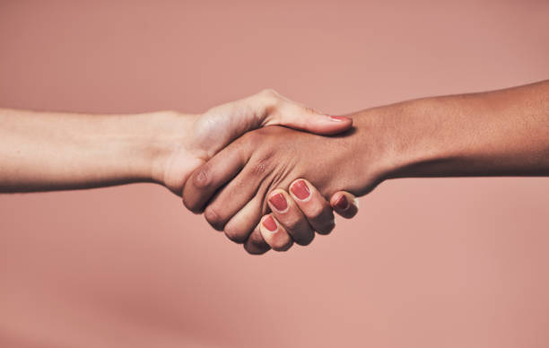 Let's do it together Shot of two unrecognizable women shaking hands racial equality photos stock pictures, royalty-free photos & images
