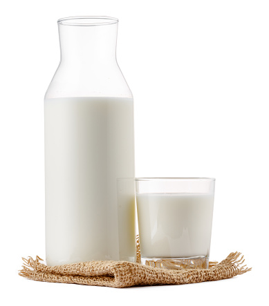 Glass bottle and cup of fresh milk isolated on white