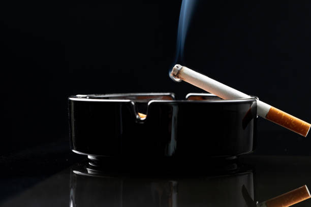 istock Burning cigarette in a black ash tray 1280161071