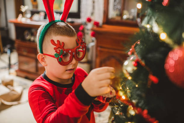 istock Caucasian boy decorating Christmas tree at home 1280163204