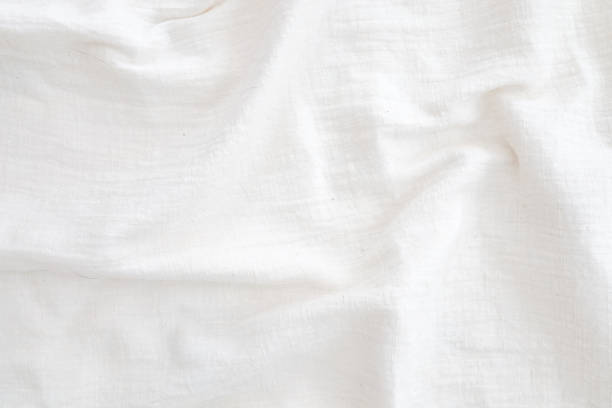 istock Fabric backdrop White linen canvas crumpled natural cotton fabric Natural linen top view  background  Organic Eco textiles White Fabric texture 1280164562