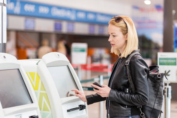 istock Beautiful Woman Using Atm At Airport 1280164725