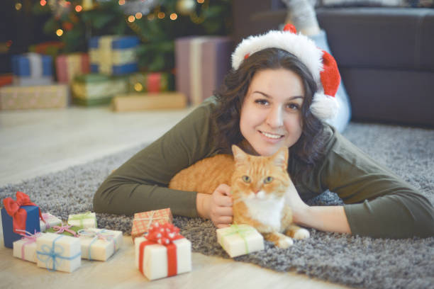 istock young woman in christmas interior with ginger cat 1280167099