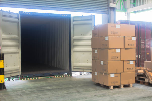 istock loading shipment carton boxes and goods on wooden pallet at loading dock from container 1280168720