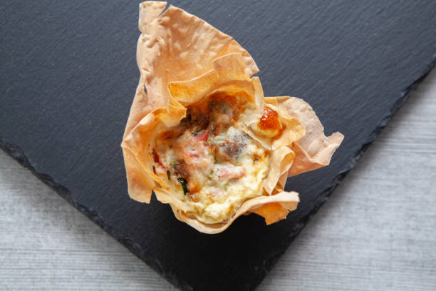 istock A breakfast muffin on a black slate surface, photographed directly above 1280168818