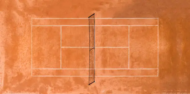 View from above, aerial view of a public, empty clay court. A clay court is a tennis court that has a playing surface made of crushed stone, brick, shale, or other unbound mineral aggregate.
