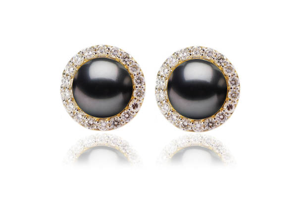 Black Pearl Earring with Prong Studded Diamond Halo Earring in Yellow Gold stock photo