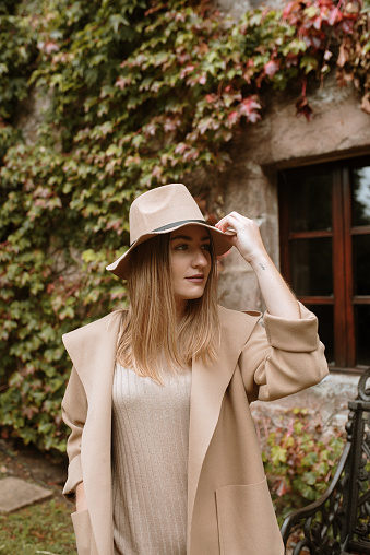 Young woman wearing autumn clothes with beige / light brown tones