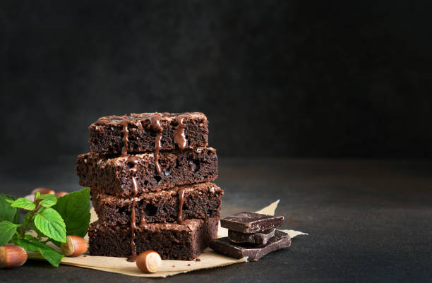 istock The classic American cake is brownie. Chocolate cake with nuts on a black background. 1280170891