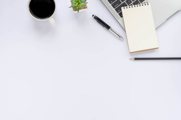 istock Top view above of White office desk table with keyboard, notebook and coffee cup with equipment office supplies. Business and finance concept. Workplace, Flat lay with blank copy space. 1280171883
