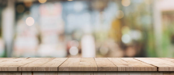 istock Empty wood table and blurred light table in coffee shop and cafe with bokeh background. product display template. 1280172133