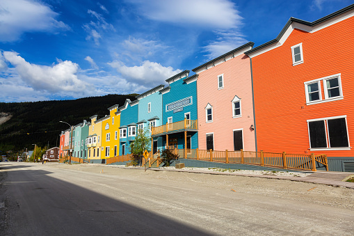 Dawson City, Yukon, Canada - August 27, 2020: Colorful Historic Buidings in a small touristic town during a cloudy summer day.