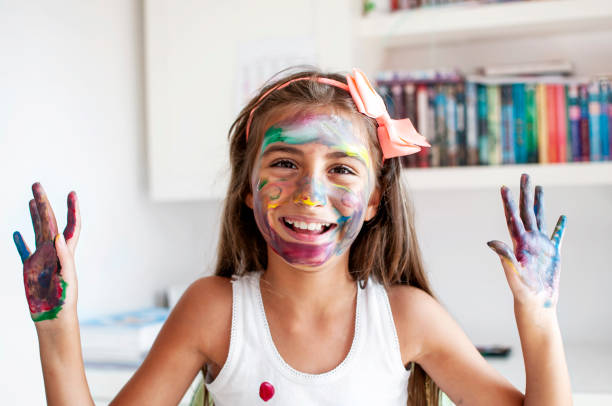 istock Cute girl playing with paints 1280173401