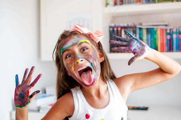 istock Cute girl playing with paints 1280174345