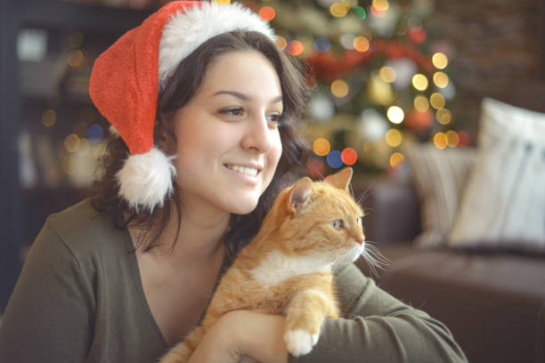 istock young woman in christmas interior with ginger cat 1280176208