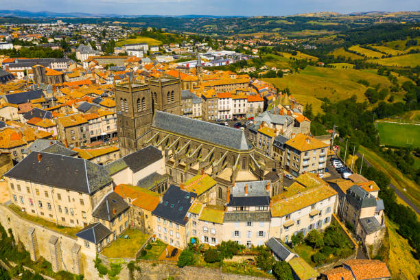 Drone view of walled French town of Saint-Flour with Cathedral Picturesque summer view from drone of walled French town of Saint-Flour with Saint-Pierre Cathedral, Cantal department auvergne rhône alpes photos stock pictures, royalty-free photos & images